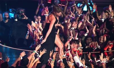 Taylor Swift holding fans on stage