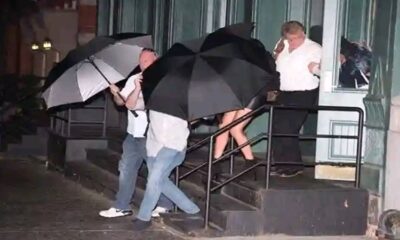 Taylor Swift covered with Umbrella by Body guard