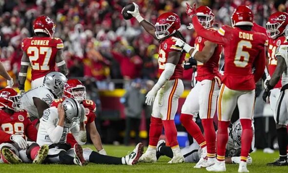 Kansas City Chiefs linebacker Nick Bolton (32) holds the recovered ball after a fumble