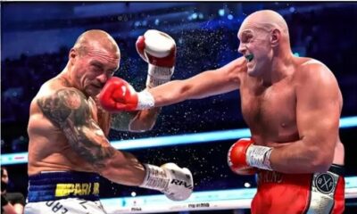 Usyk and Tyson Fury fight in ring,