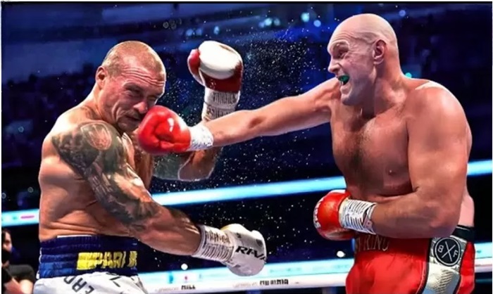 Usyk and Tyson Fury fight in ring,